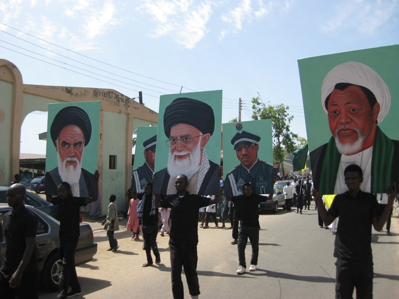 IMN members hold posters of Khomeini, Khamenei, and Zakzaky during 2015 Quds Day rally (Source: Islamic Invitation Turkey)