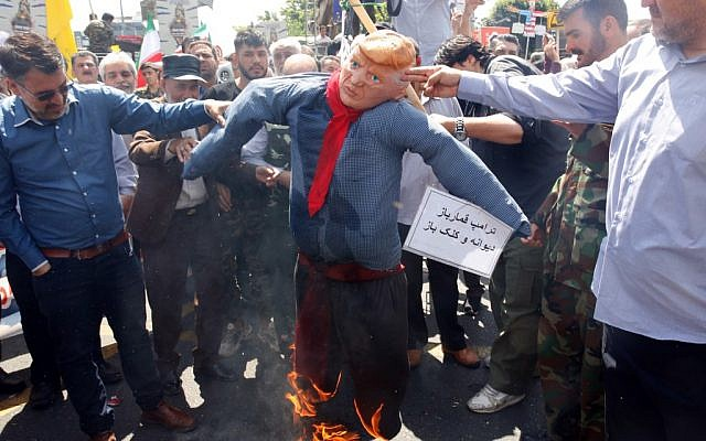 Demonstrators burning effigy of President Trump