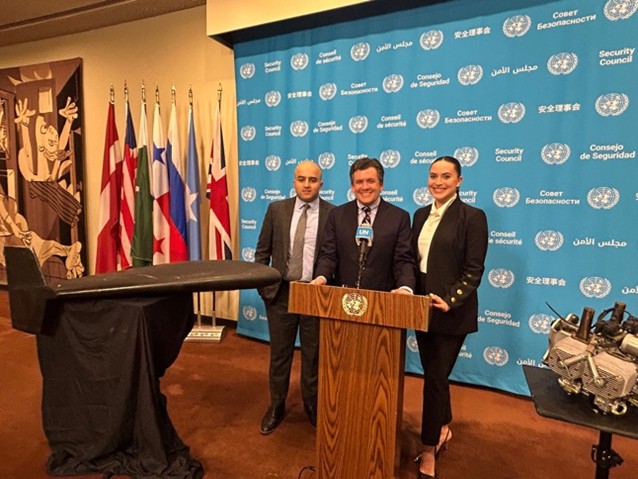 three people standing at podium