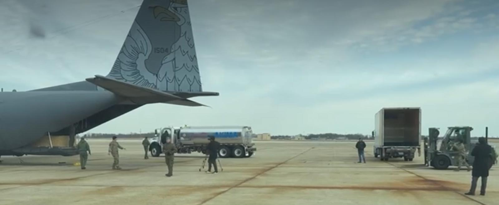 A group of people standing next to a plane
AI-generated content may be incorrect.