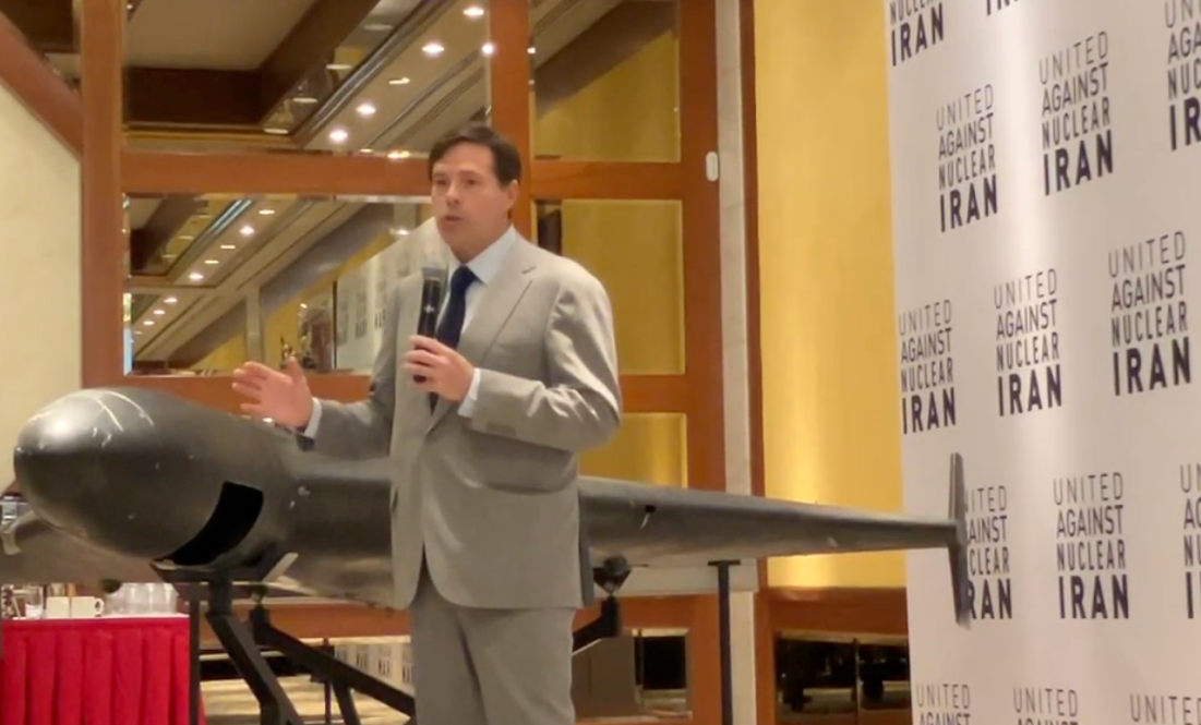 A person in a suit holding a microphone
AI-generated content may be incorrect.