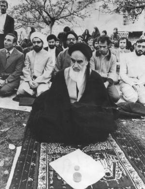 Hassan Rouhani (2nd from the left) praying with Ayatollah Khomeini and his revolutionary followers in Paris in 1978.