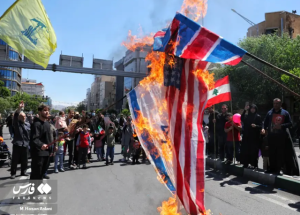 Flags of the U.S., Israel, and the U.K. Set on Fire, with Hezbollah's Flag in the Background